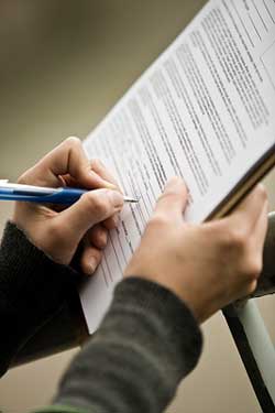 Person Filling Out Tenancy Agreement Form